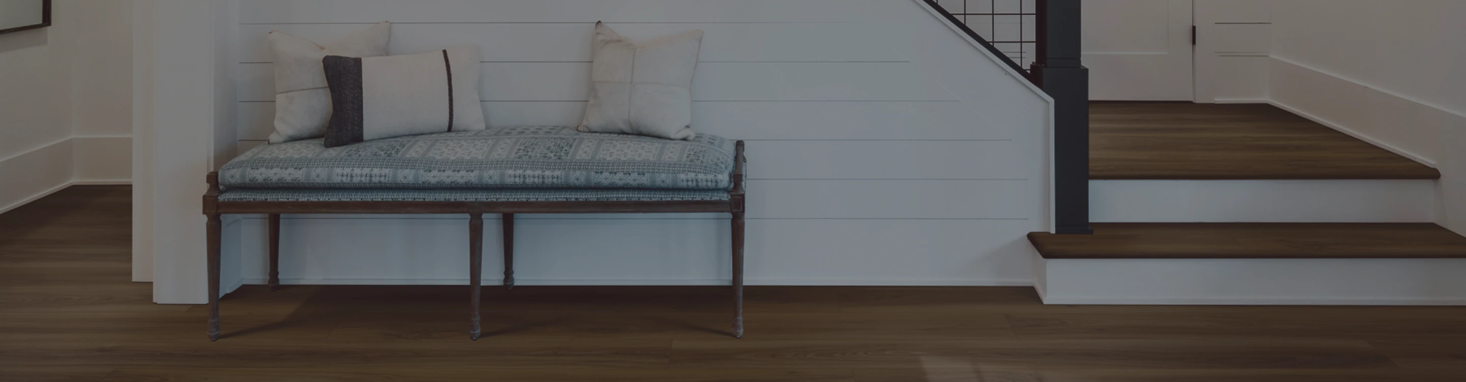 hardwood flooring in foyer with bench